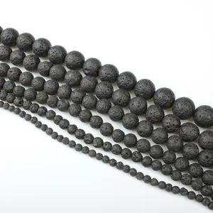Macro detail of black lava stone beads showing various sizes and porous texture for jewelry