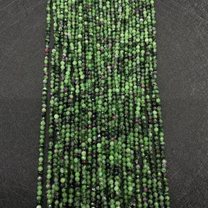 Macro detail of faceted Ruby in Zoisite round beads showing green and red minerals
