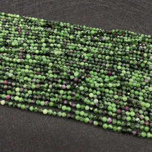 Macro detail of faceted ruby in zoisite beads showcasing natural green and red minerals