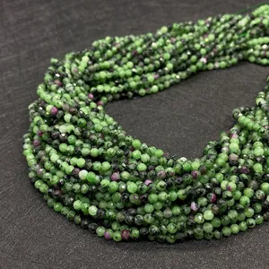 Close-up of faceted ruby in zoisite beads showing green and purple mineral texture