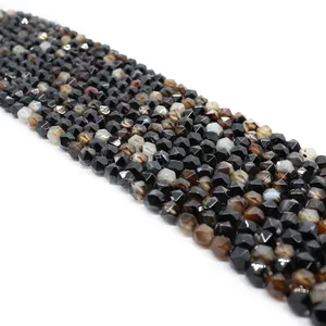 Macro view of faceted natural striped black agate beads showing detailed craft and texture