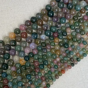 Close-up of polished natural India Agate beads with mineral textures for DIY jewelry