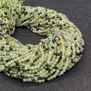 Macro detail of natural faceted prehnite beads with green and black mineral inclusions