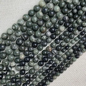 Detailed close-up of natural green stone beads in various sizes for DIY jewelry
