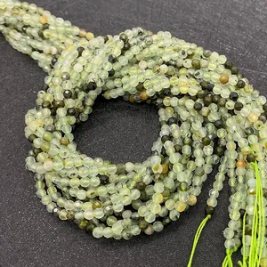Macro detail of natural faceted prehnite beads 2mm with light green gemstone texture