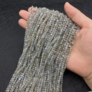 Macro shot of 2-3mm faceted labradorite beads showing blue flashes on dark background