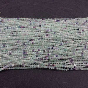 Detailed macro view of 2mm faceted green and purple natural fluorite gemstone beads