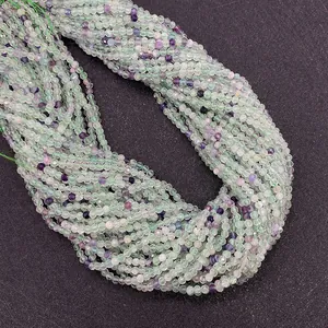 Close-up of faceted natural fluorite crystal beads in green and purple for DIY jewelry