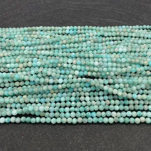 Macro shot of natural faceted amazonite round beads in light blue-green tones for DIY jewelry