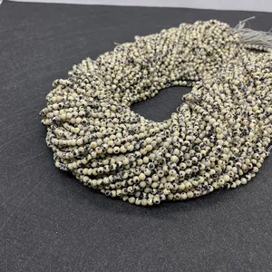 Macro shot of natural Dalmatian Jasper faceted beads arranged in multiple strands