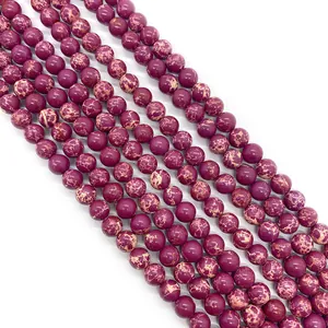 Macro shot of deep purple imperial jasper round beads showing natural veined texture