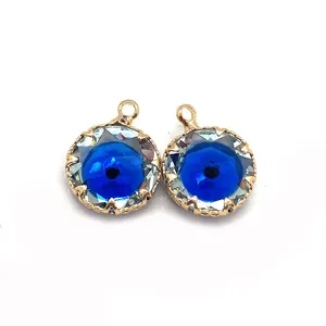 Detailed macro of two blue faceted evil eye stone pendants with gold metal frames