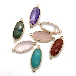 Set of seven oval faceted natural stone connectors with gold plated double loops