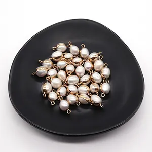 Detailed macro view of irregular baroque pearl pendants with gold-plated metal loops for DIY