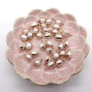 Detailed view of natural freshwater rice pearls with gold plated edges for DIY jewelry