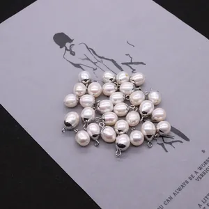 Macro shot of white teardrop freshwater pearls with silver metal bail for DIY jewelry