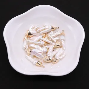 Nahaufnahme barocker Süßwasserperlen-Anhänger mit Goldkappen in einer Blumenschale