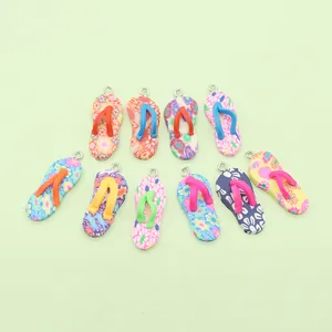 Detail view of colorful flip-flop charms with floral patterns and metal rings for DIY
