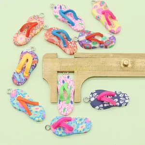 Macro shot of colorful polymer clay flip-flop charms with floral prints and metal rings