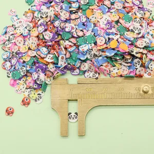 Close-up of 5mm animal-shaped polymer clay beads being measured with a caliper