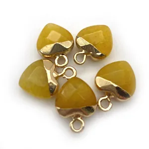 Macro shot of five yellow faceted heart stone pendants with gold metal hanging loops