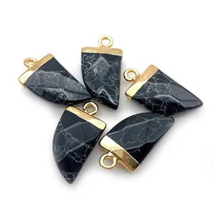 Detail view of five marble stone pendants with gold bails in a horn shape for jewelry DIY