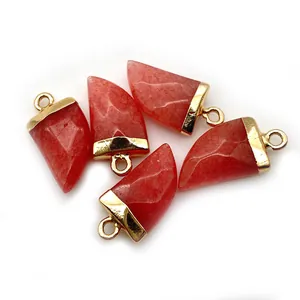 Macro view of five red faceted stone horn pendants with elegant gold caps and rings