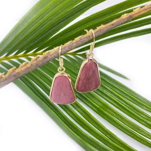 Detail of pink natural stone drop earrings with gold metal edging and hooks