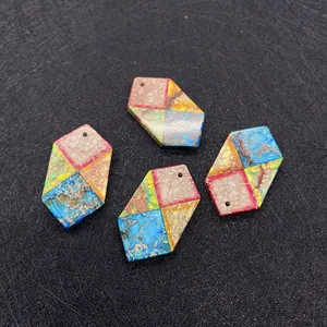 Close-up of four hexagonal colorful imperial stone pendants with pre-drilled holes