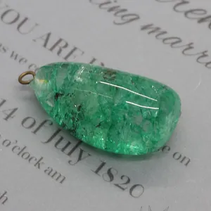 Vue macro d'un pendentif en cristal vert avec texture naturelle et bélière en bronze