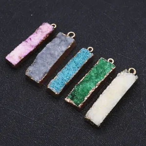Macro shot of five colorful rectangular druzy stone pendants with gold metal plating edges