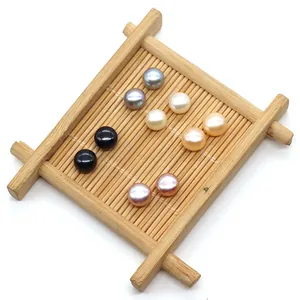 Flat round freshwater pearls in white, black and purple on a bamboo mat background