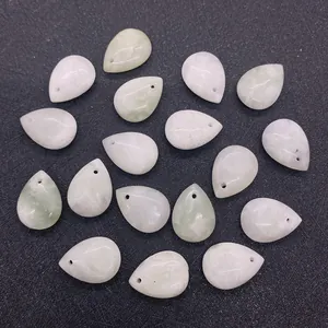 Detailed view of teardrop shaped pale green jade stones with drilled holes for DIY jewelry