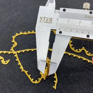 Detailed measurement of 2mm golden ball chain necklace using a digital caliper