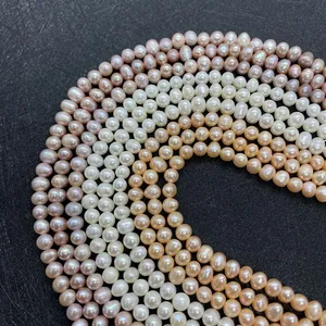 Detailed macro view of white, pink, and orange natural freshwater pearl strands