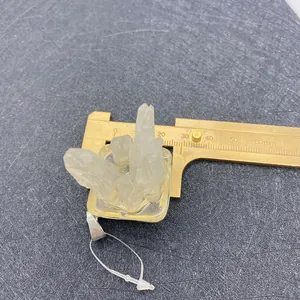 Measuring natural irregular quartz crystal cluster pendant with brass vernier caliper