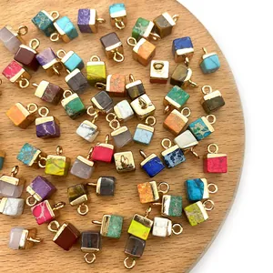 5x10mm cube emperor stone pendants with gold ring connectors on a wooden tray
