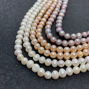 Close-up of four layered strands of natural freshwater pearls in white, pink and gold hues