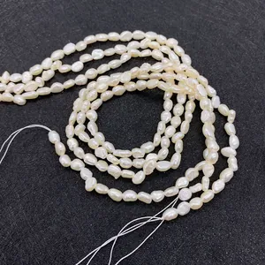 Macro shot of 7-8mm irregular white freshwater pearls on a textured black background