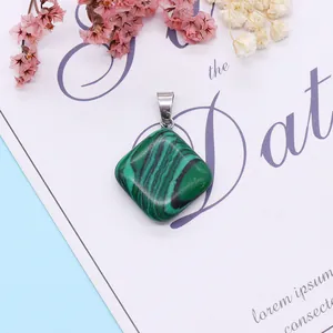 Detail of rhombic malachite pendant with natural green stripes and silver clasp