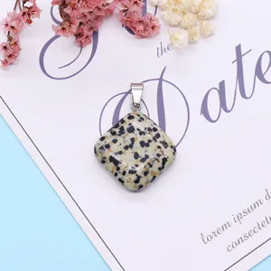 Macro detail of rhombus dalmatian jasper pendant with silver clasp on elegant background