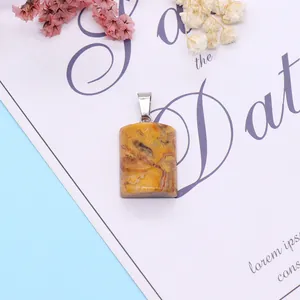 Natural bumblebee jasper rectangular pendant with silver clasp on a decorative floral card