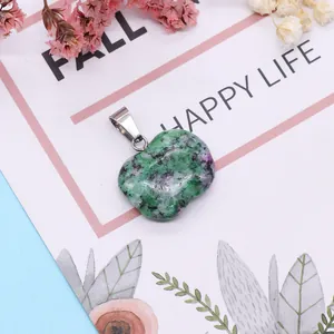 Apple-shaped Ruby in Zoisite stone pendant with silver clasp on a floral background
