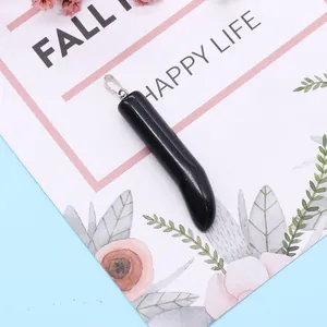 Polished black crystal chili pepper pendant with silver bail on a floral gift card