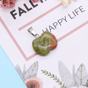 Natural heart-shaped unakite gemstone pendant with silver metal clasp on floral background