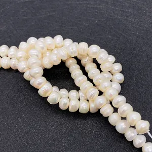 Macro view of natural freshwater pearls showing creamy white luster and organic textures