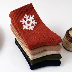 Five pairs of knitted cotton mid-calf socks with snowflake patterns in cozy autumn colors
