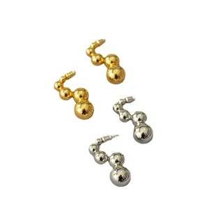 Minimalist hollow sphere earrings in polished gold and silver finish on white background