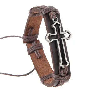 Detail of vintage braided leather bracelet with silver-tone metal cross charm for men