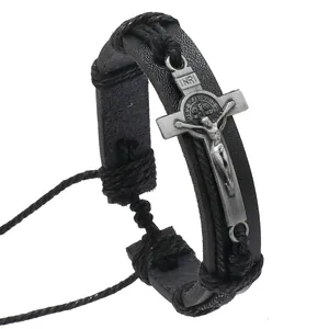 Close-up of adjustable black leather bracelet with vintage silver crucifix and St. Benedict medal